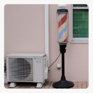 Outdoor air conditioner unit on tiled floor.