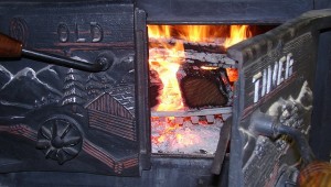 Photo of an old woodstove with a fire inside. 