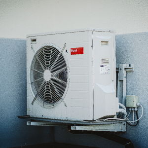 Air conditioning unit outside mounted to a wall.