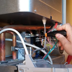 Person repairing a water heater.