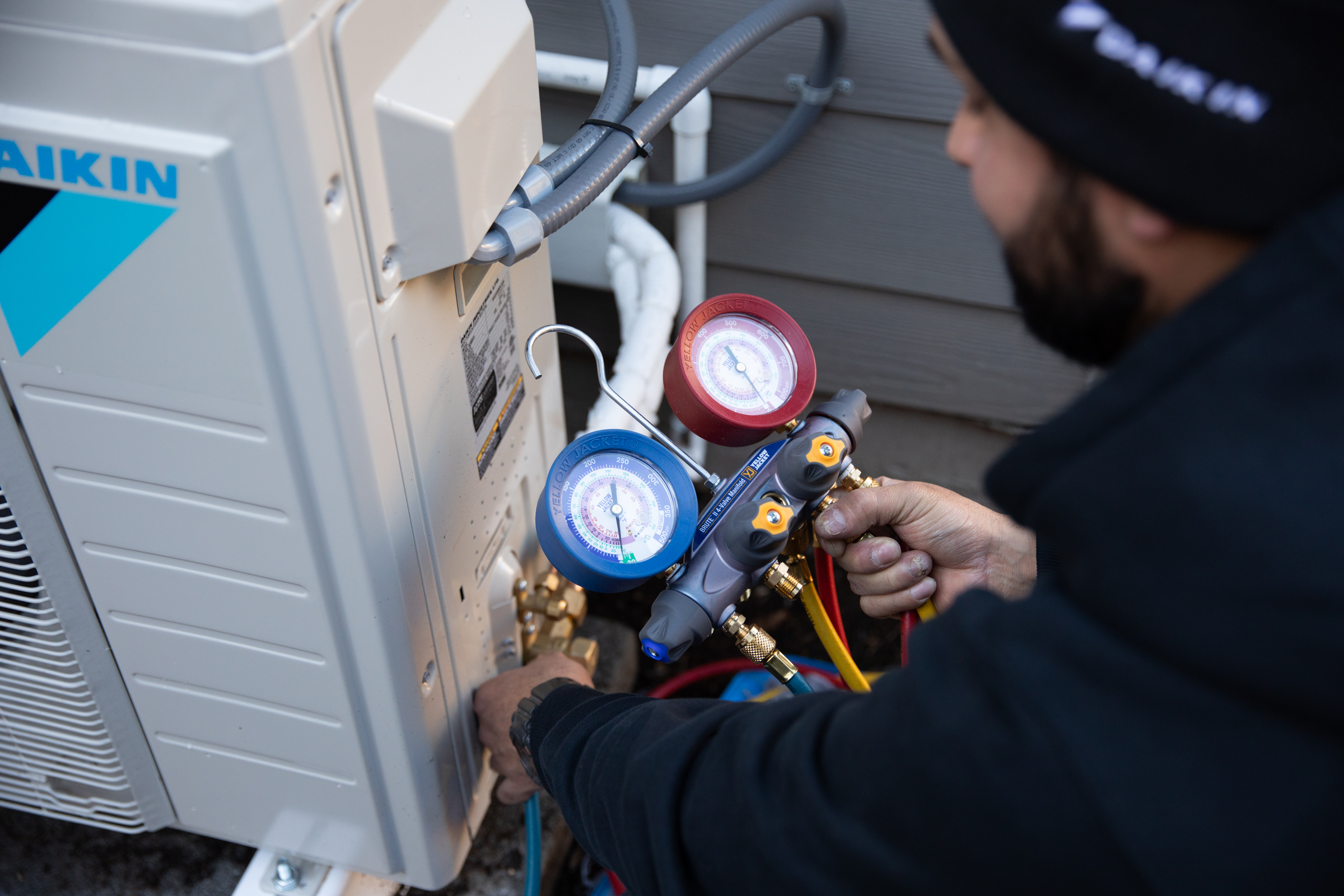 Technician uses tools to ensure unit is working properly